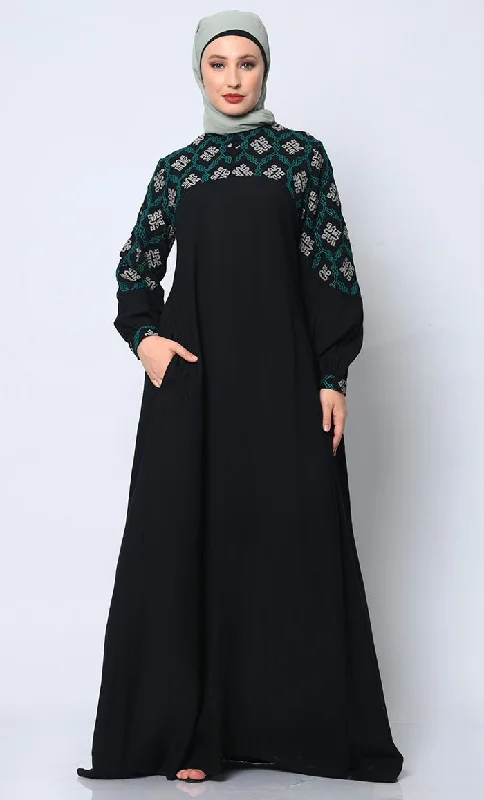 Elegant Temperament Elegant Simplicity: Embroidered Black Abaya with Box Pleats and Dual Pockets Elegant Temperament Elegant Simplicity: Embroidered Black Abaya with Box Pleats and Dual Pockets